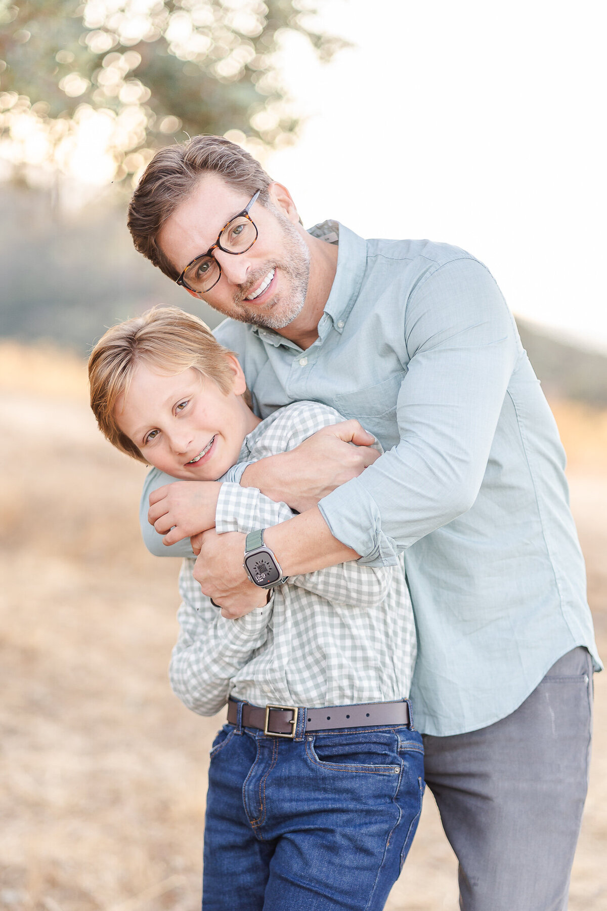 bay area family photography with dad and sun hugging on a hillside
