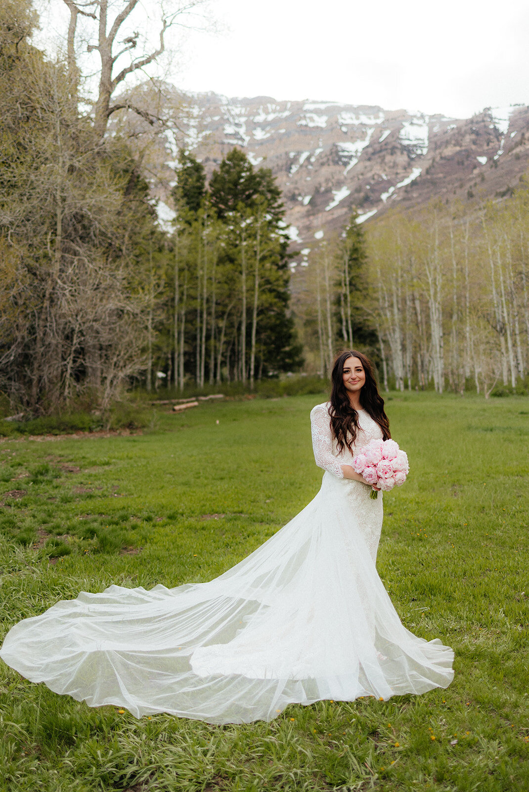 Lace wedding dress with long train bridal photos at Aspen Grove in Utah.