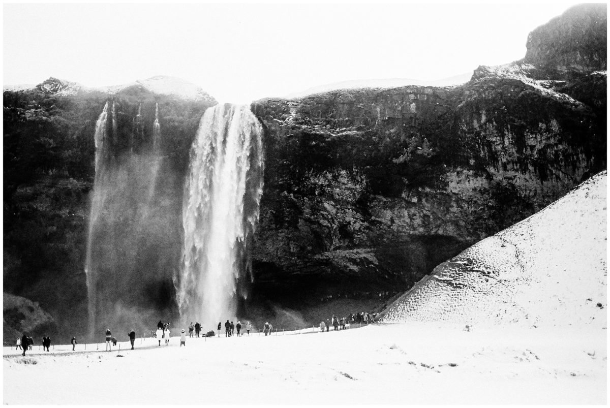 black and white photo of skogafoss waterfall in iceland