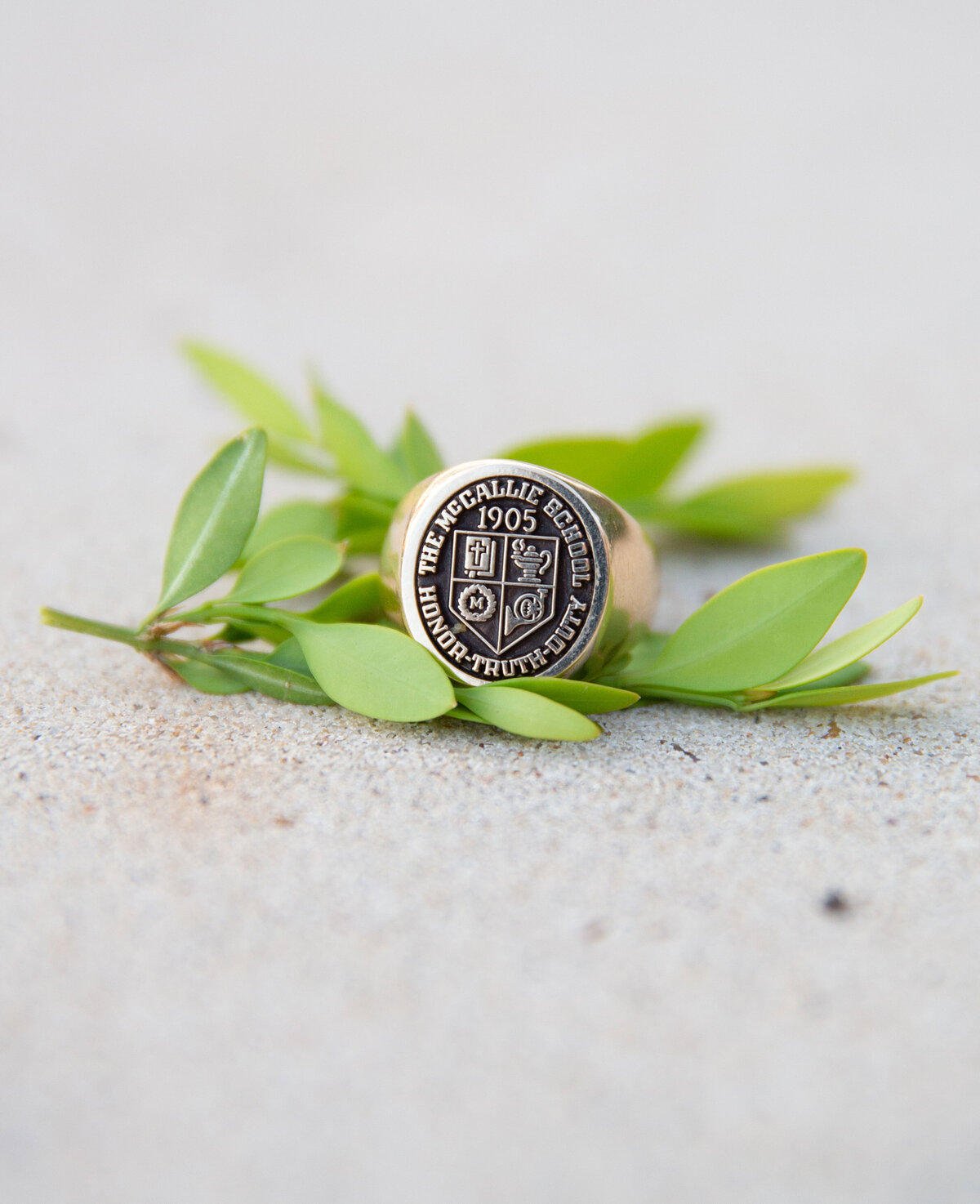 class ring sitting on green leaves at McCallie School in Chattanooga