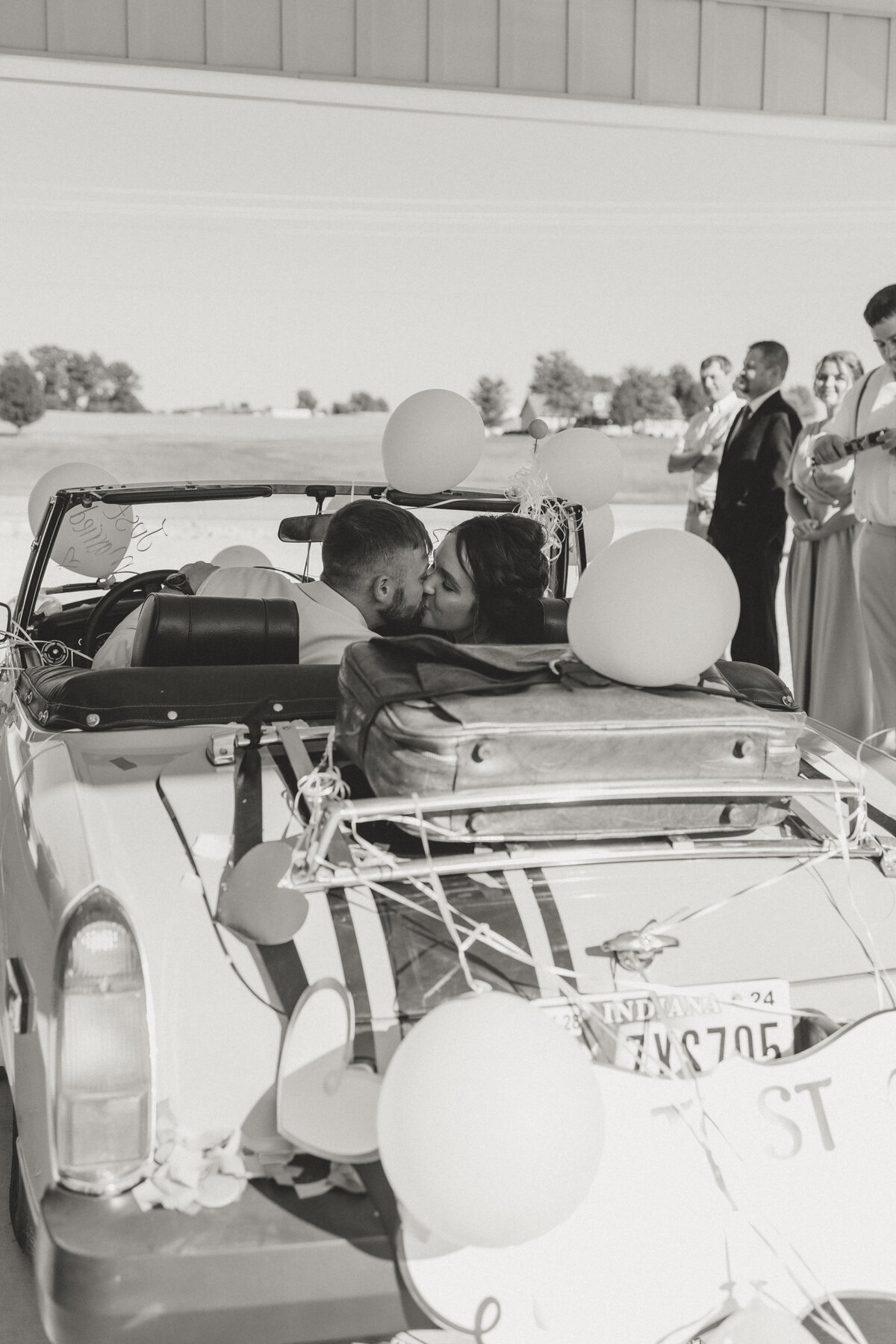 Photo of a couple in their getaway car at thaeir wedding in Bloomington, INDIANA