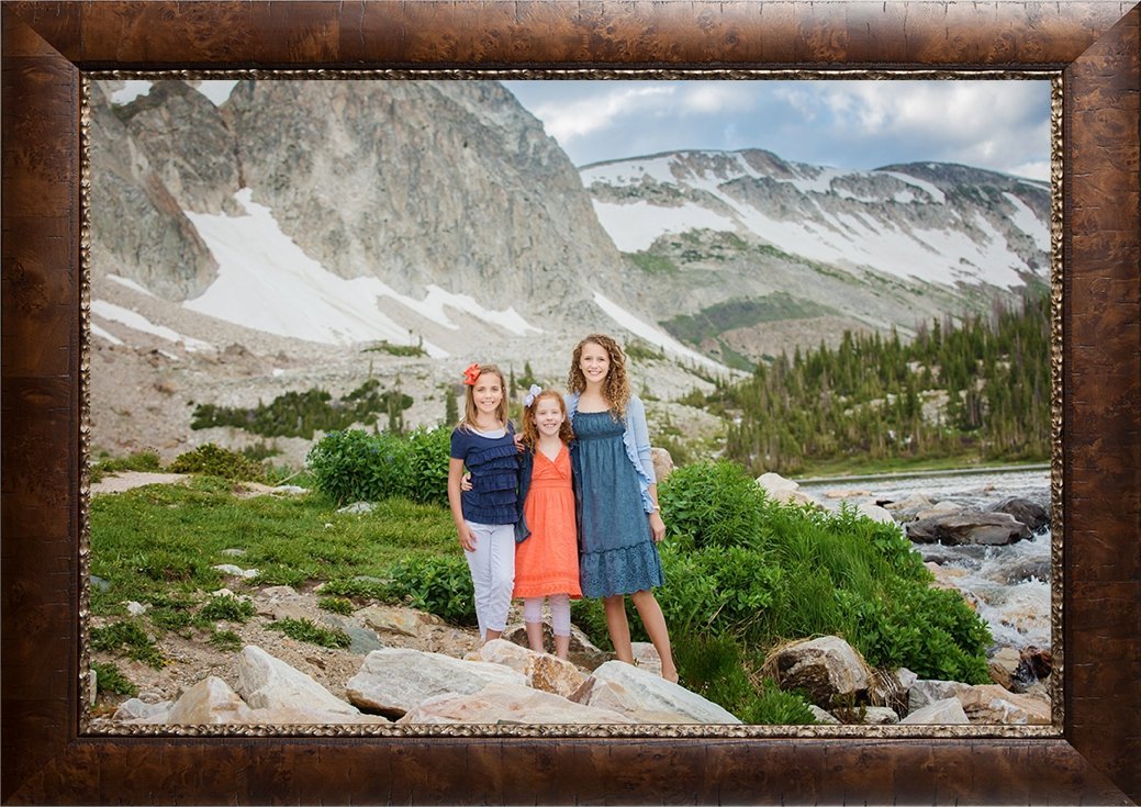 Three girls dressed in coral and blue in front of Lake Marie.