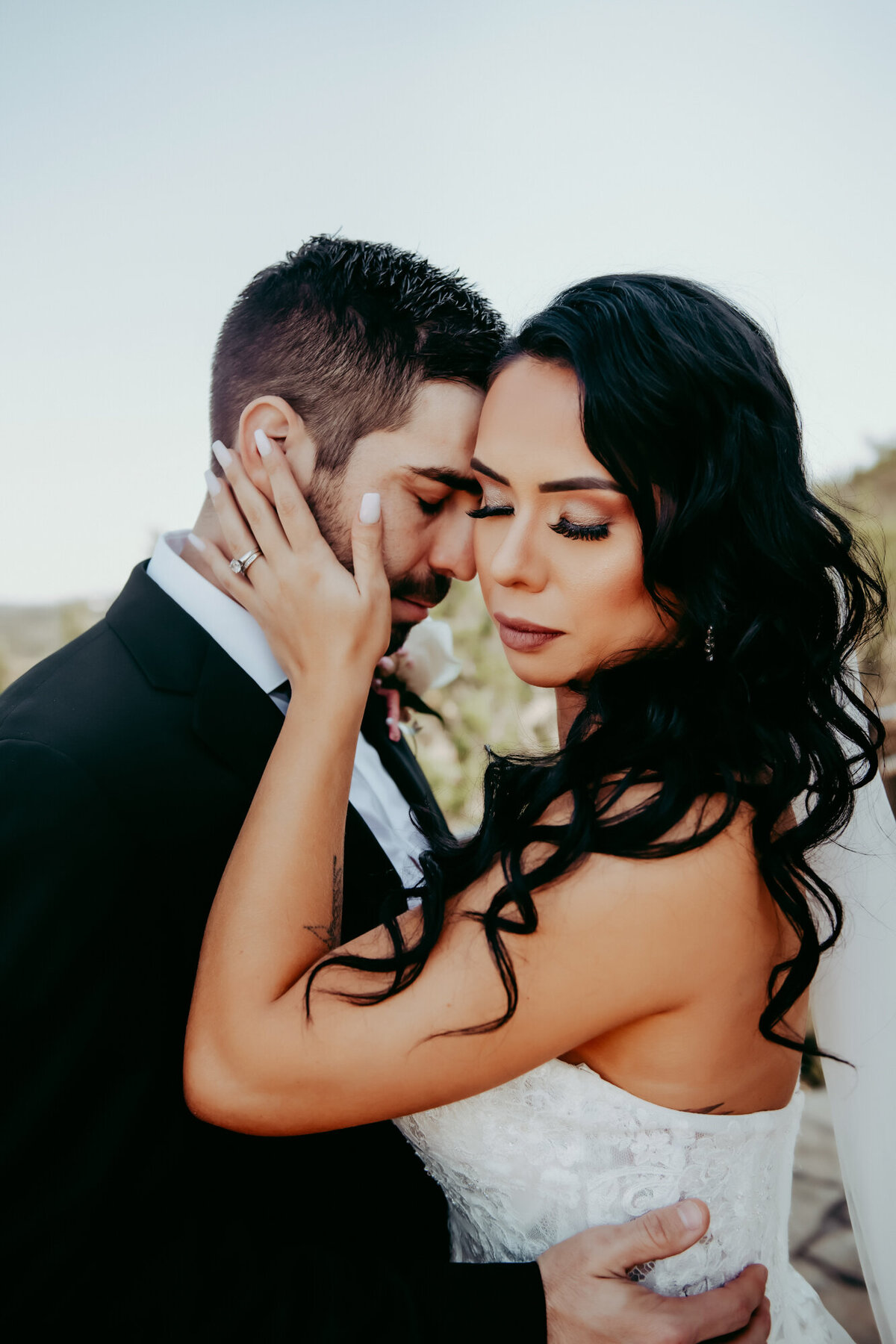 Couples Photography, a bride and groom hold each other tenderly, eyes closed as they embrace