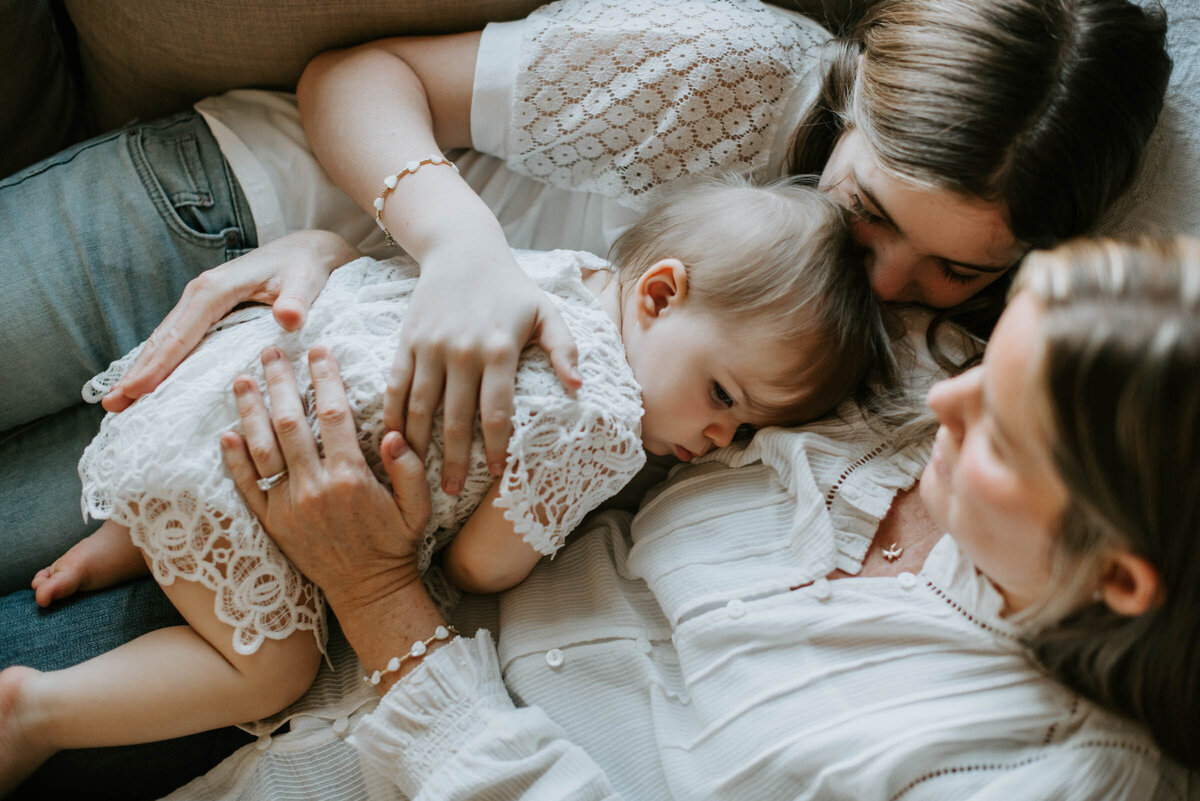 Mother and daughters hugging in-home First Birthday Photography