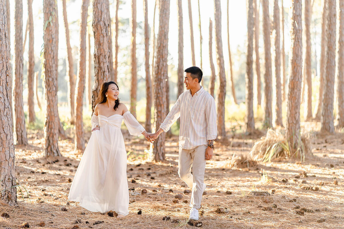Couple having fun during their engagement portrait session in Gold Coast pizzey park pine forest