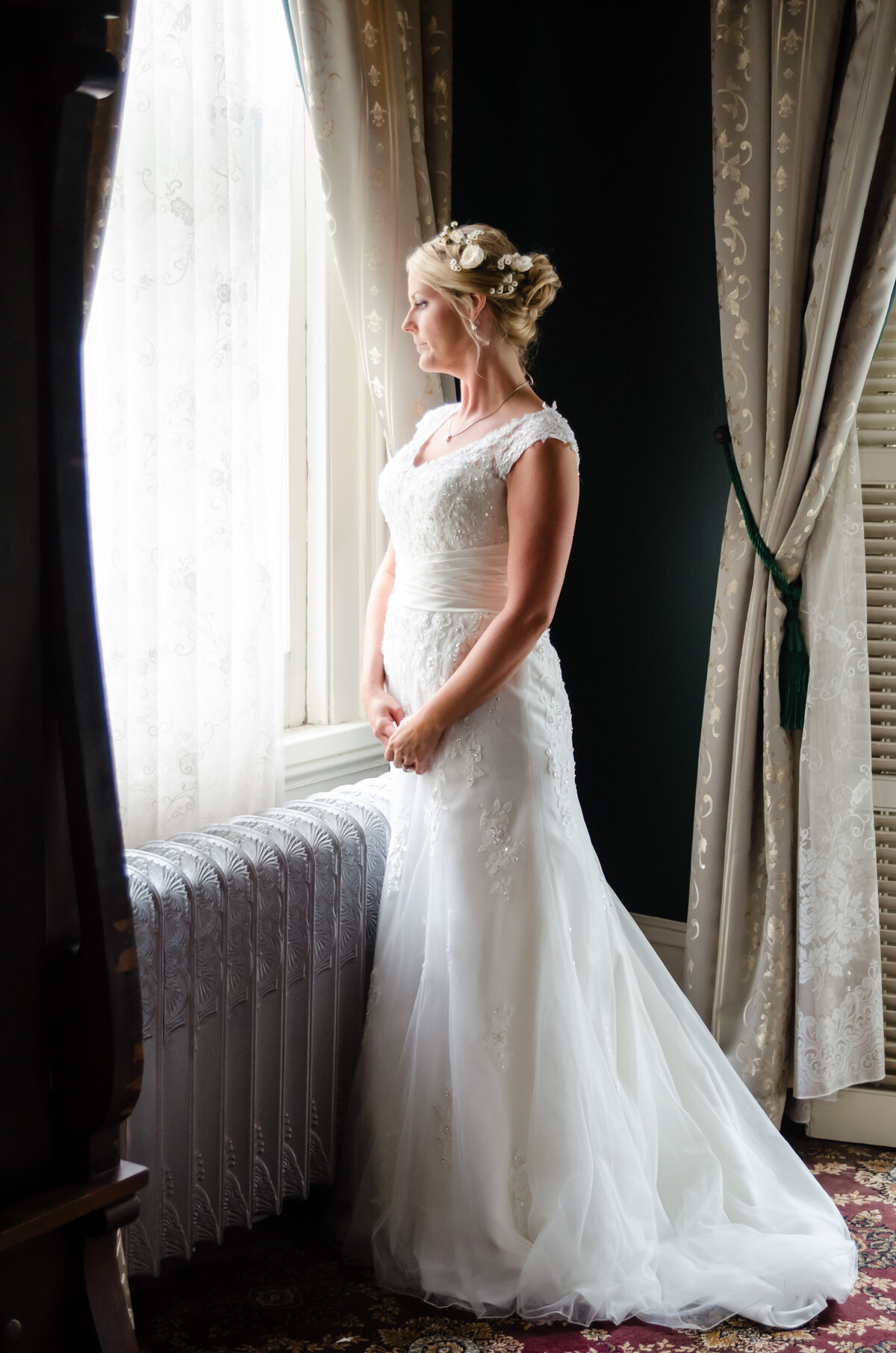 Beautiful bridal portrait photography: Bride gazes out the window of the Columns Hotel on St. Charles in New Orleans, LA