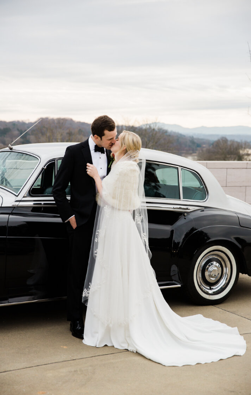wedding couple kissing in front of a classic car in Knoxville