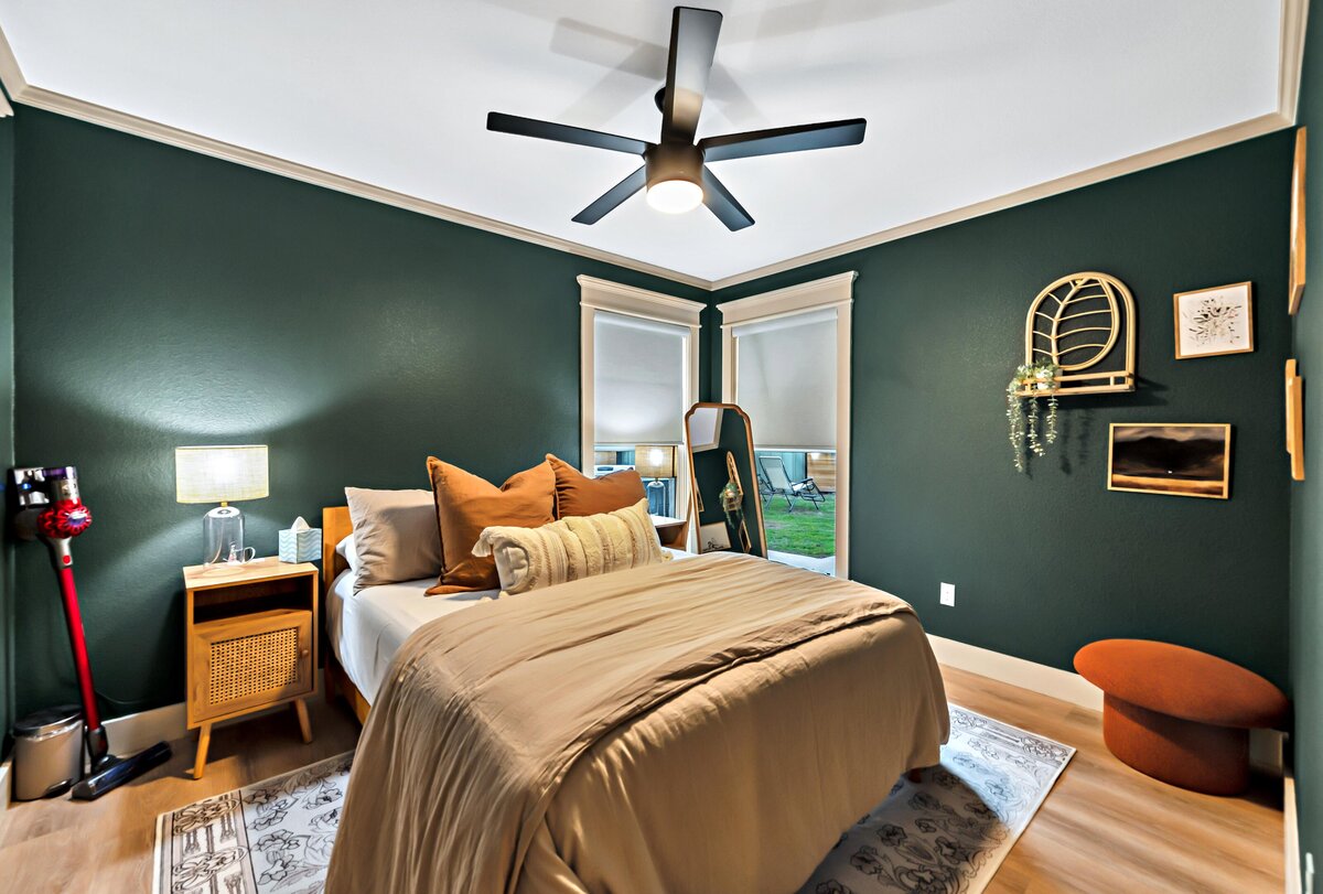 Bedroom with comfortable bedding in this three-bedroom, three-bathroom vacation rental home with free wifi, outdoor theater, hot tub, propane grill and private yard in Waco, TX.