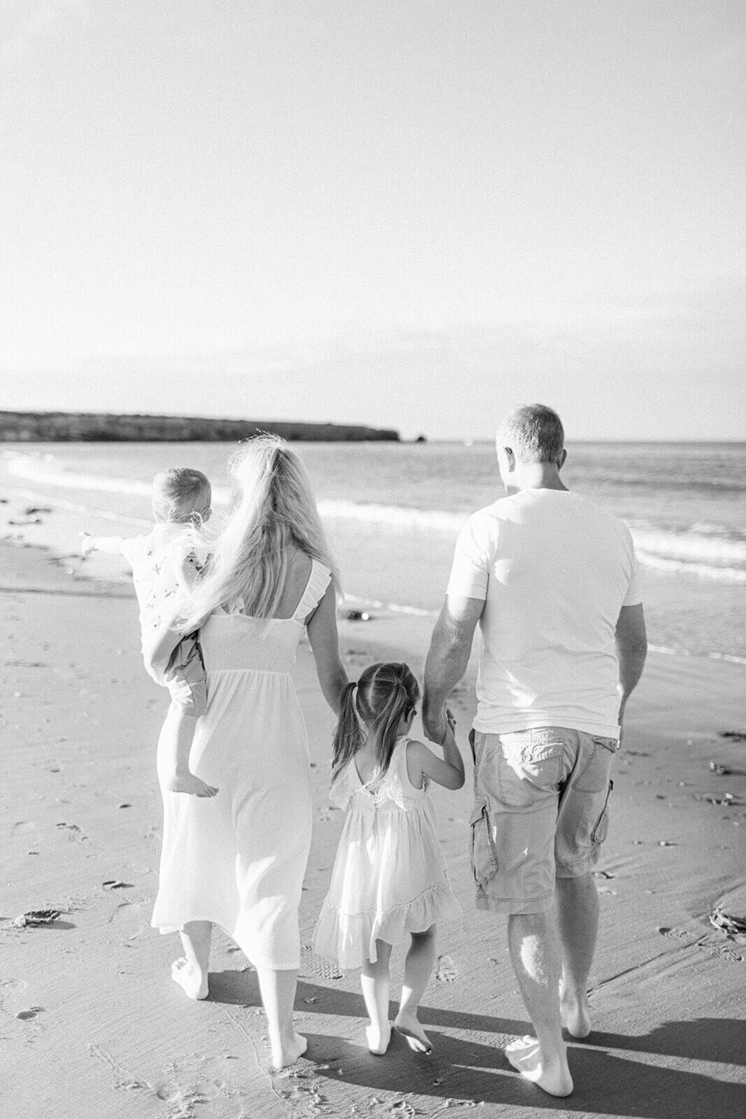 family-walking-on-the-beach