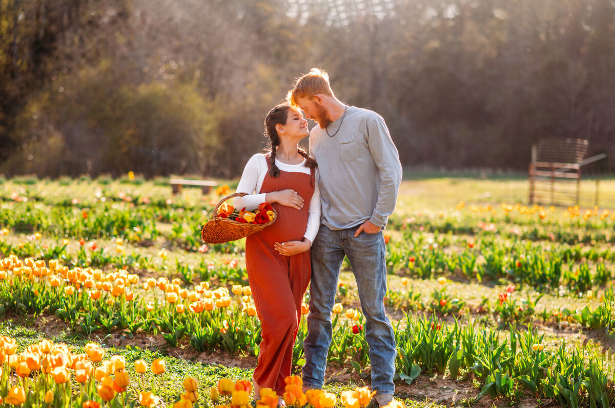 photo of Allie and Tyler cuddling in a tulip field
