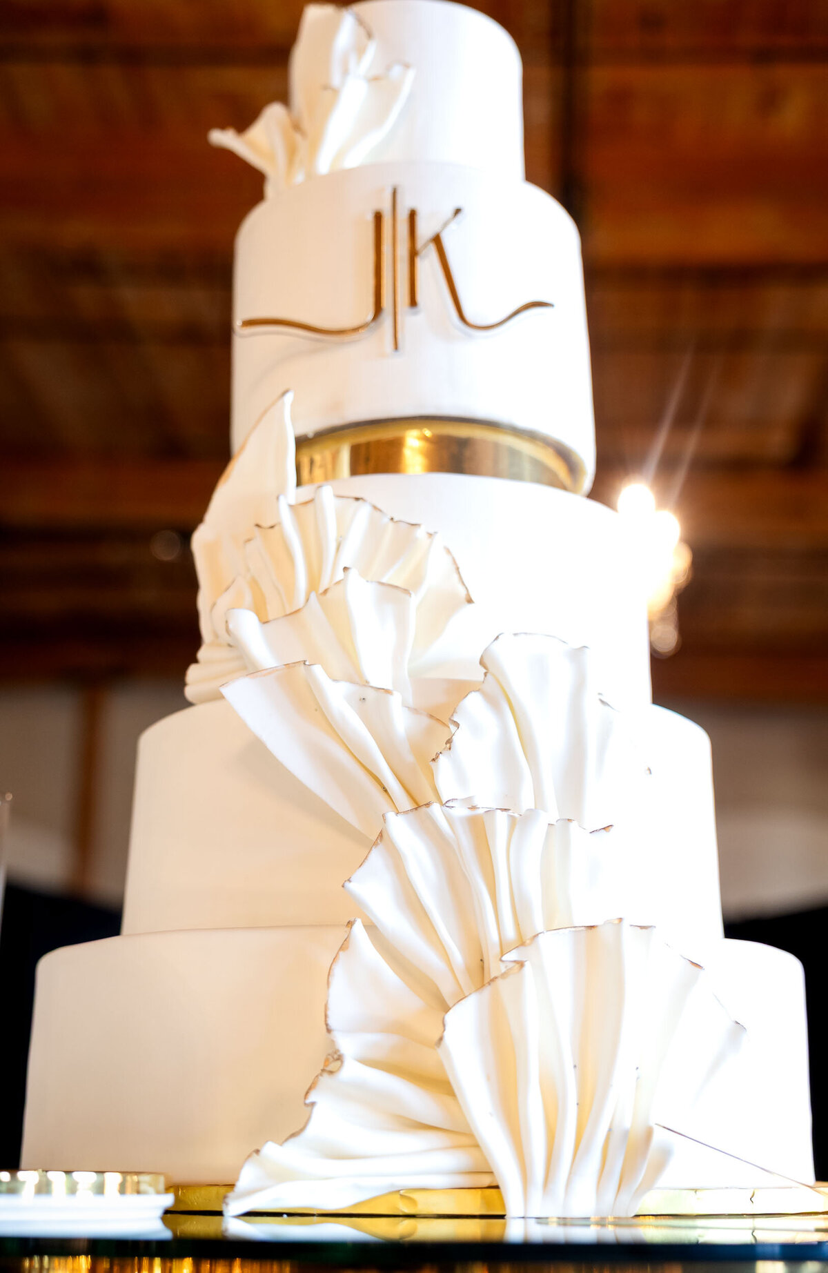 photo of an elegant wedding cake taken at  Bibb Mill Event Center during the reception 