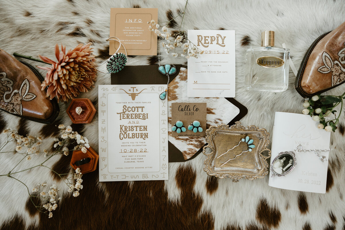 western wedding invitation suite on a cowhide rug