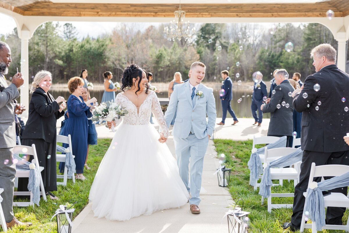 Bride and groom walking down wedding aisle