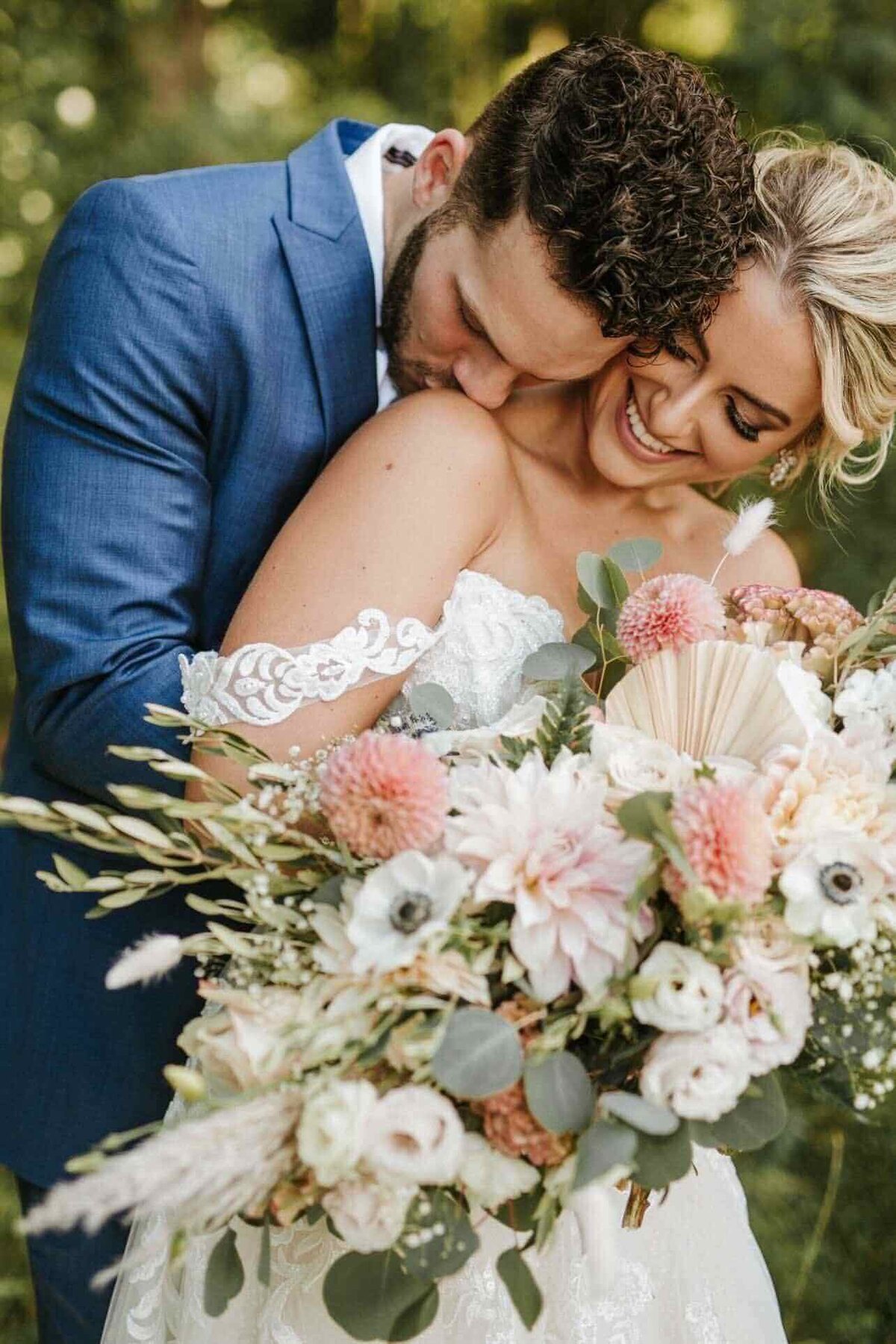 Natalie Brown wedding - groom kissing bride's shoulder