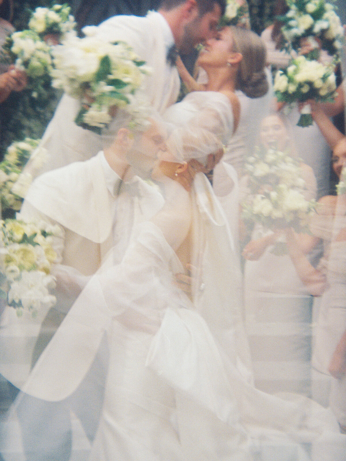 Artistic double exposure of bride and groom kissing