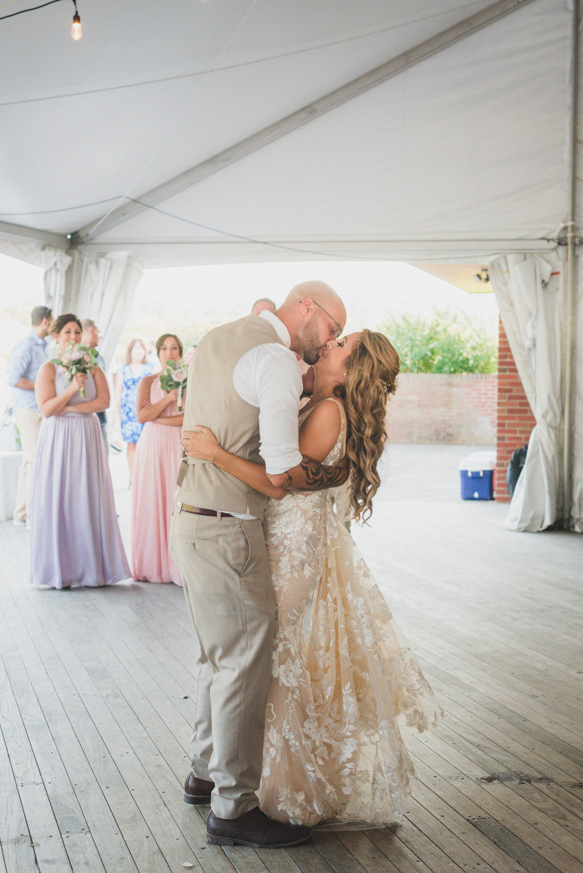 photo of bride and groom kissing on the dance floor during wedding reception at Pavilion at Sunken Meadow