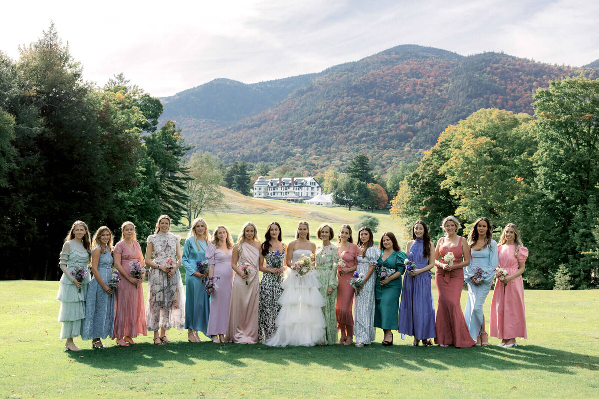 The bride and the bridesmaids at The Ausable Club golf course, hotel and mountains are in the background. Image by Jenny Fu Studio.