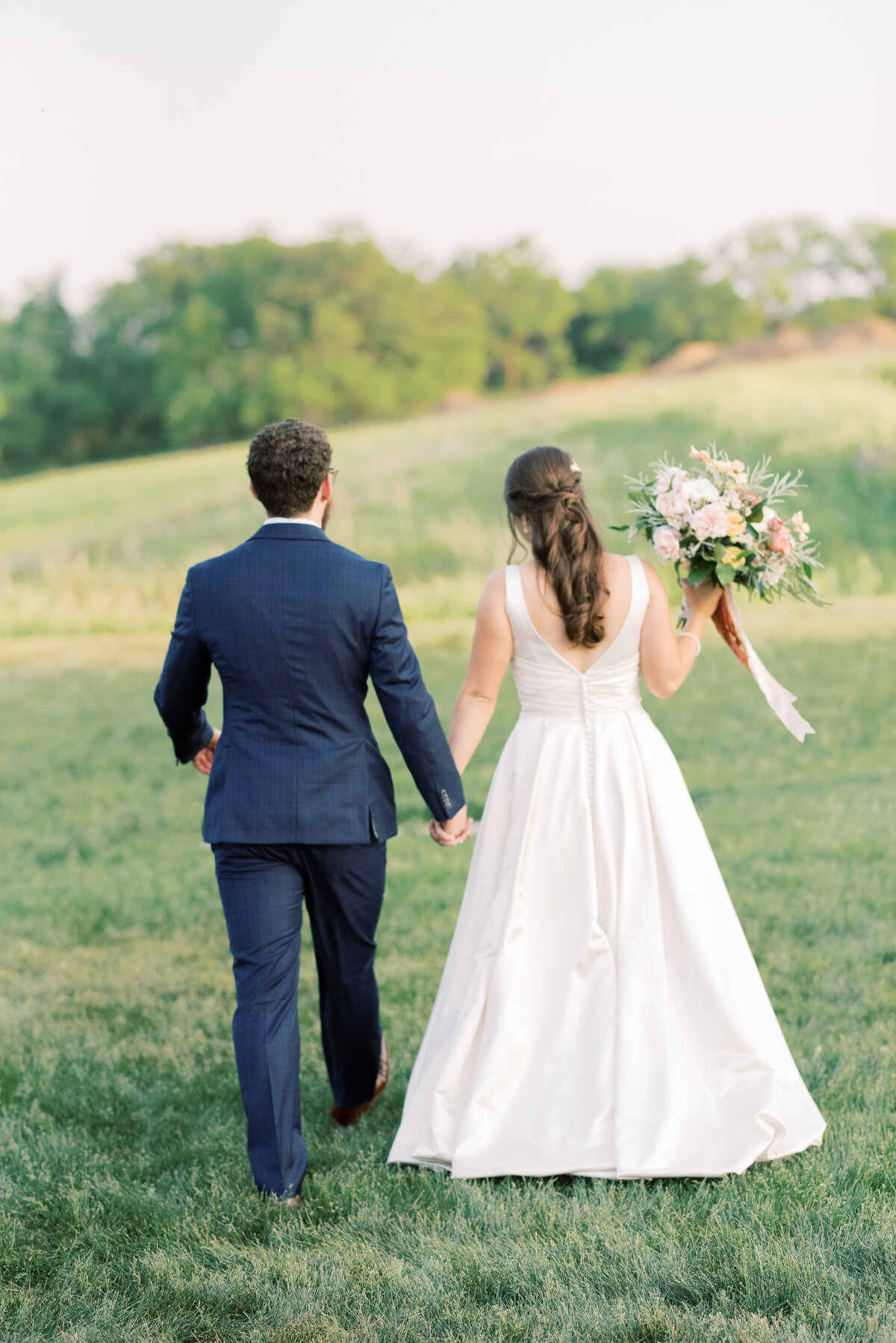 married couple walking  out to the outdoor ceremony space