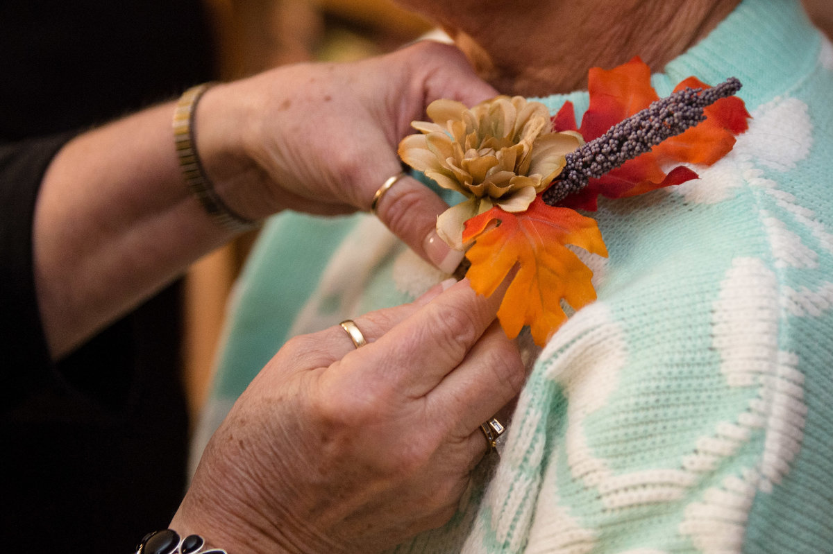 fall corsages hands pinning on