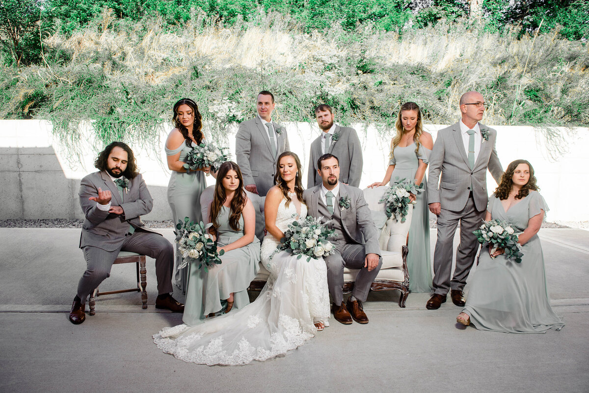 Dramatic vogue style wedding party photo outside with vintage couch