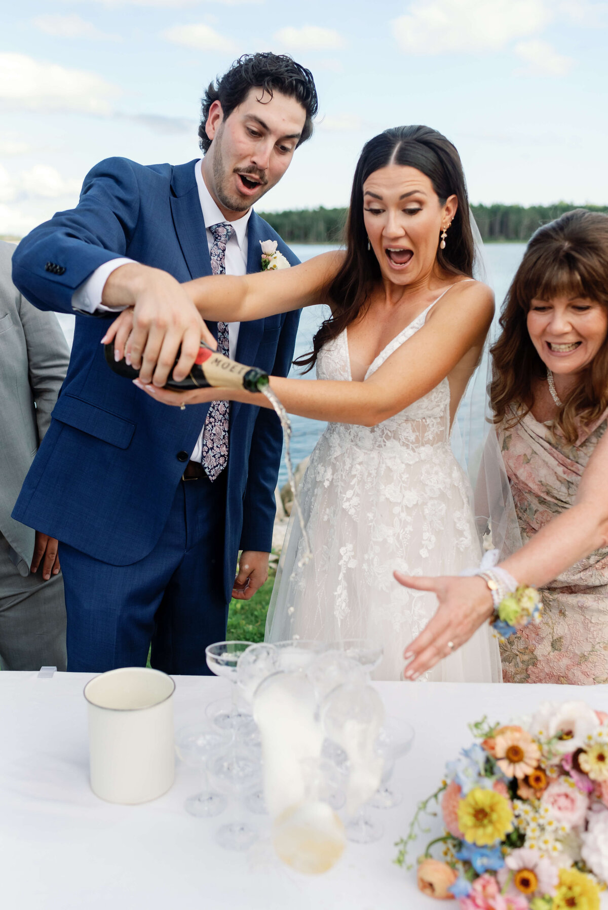 Bride and groom pouring champagne at Oak Island Resort wedding, Nova Scotia