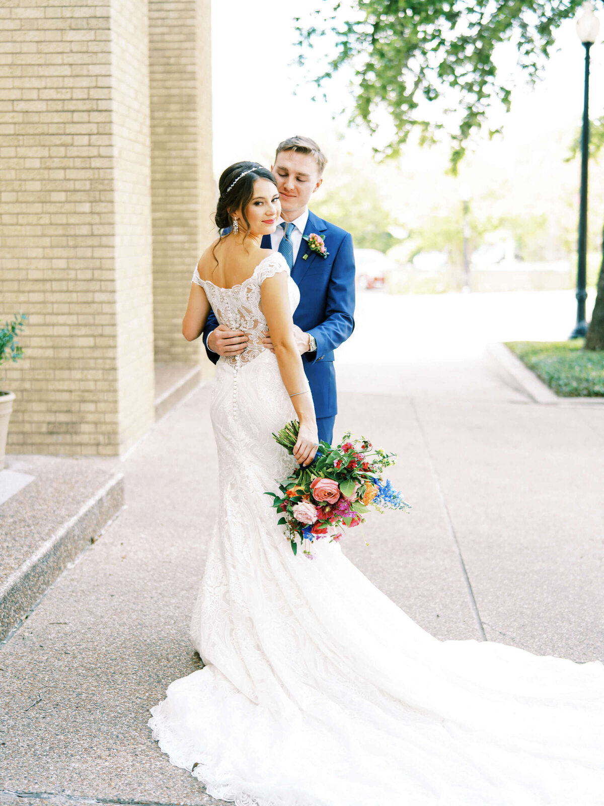 Summer bride and groom embrace at wedding chapel in Fort Worth Texas