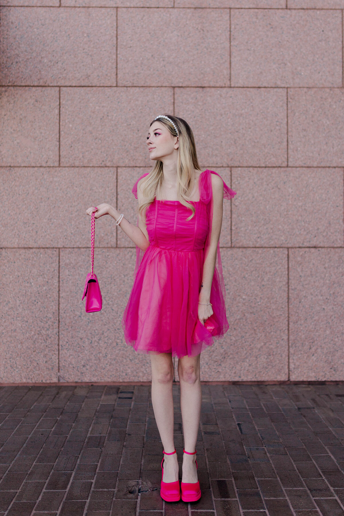 Barbie model dressed in all hot pink poses in front of the houston galleria tiffanys