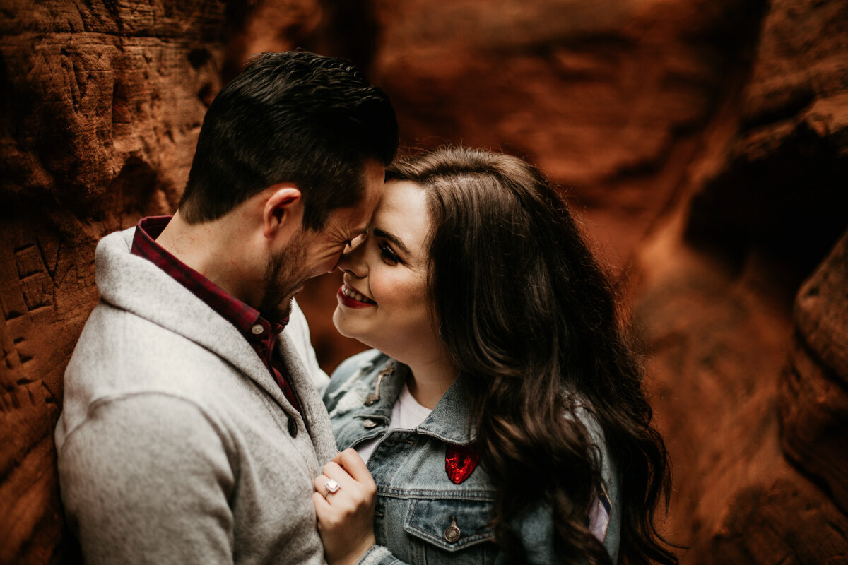 engaged couple about to kiss in red rock canyon