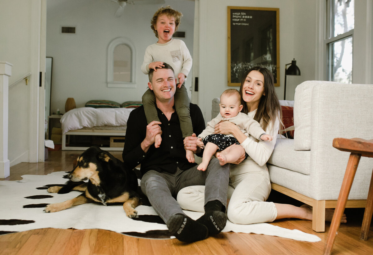 Family sitting on rug in living room at Austin family photo session