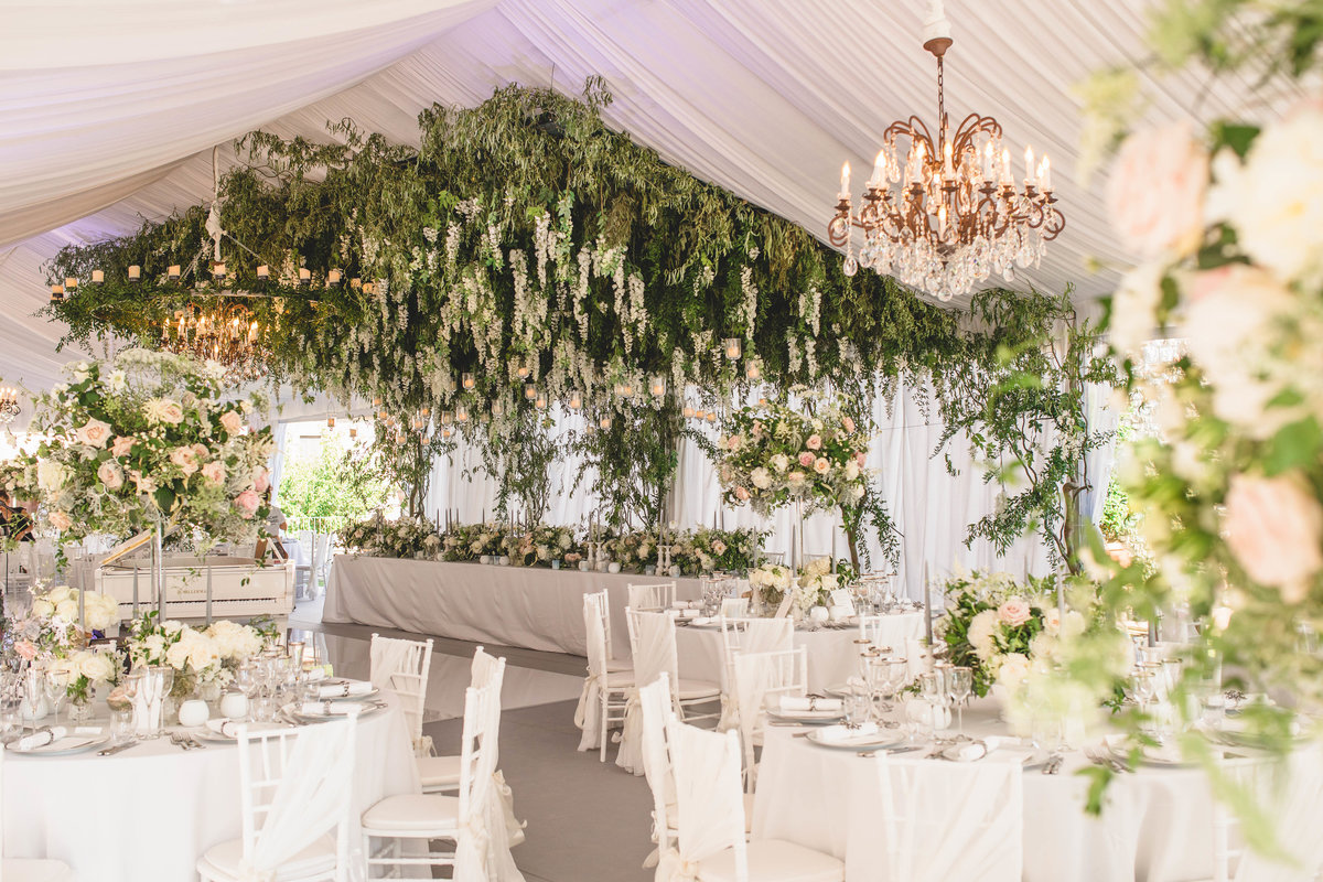 tuscany flowers wedding venue with flowers from ceiling of marquee