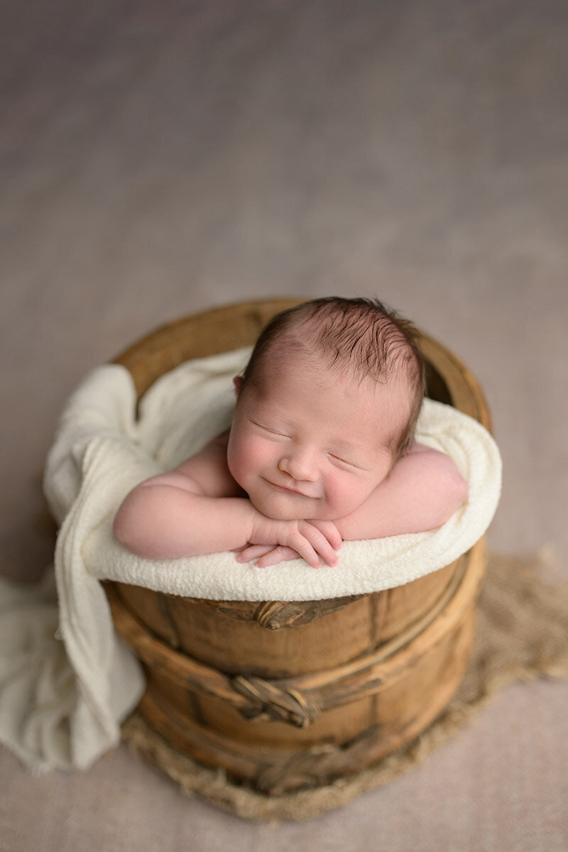 Smiling newborn posed during boston newborn photography session