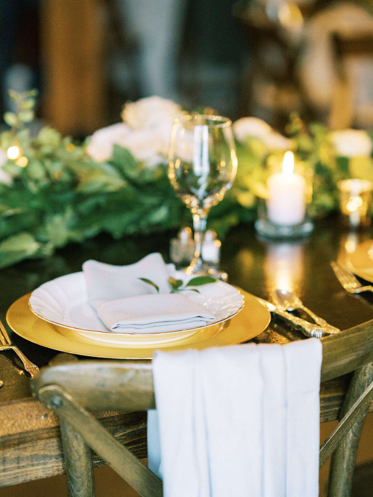 Place setting at North Texas rustic wedding with gold and greenery