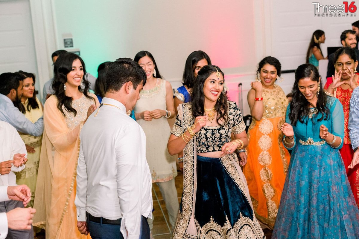A smiling Bride dances with her Groom