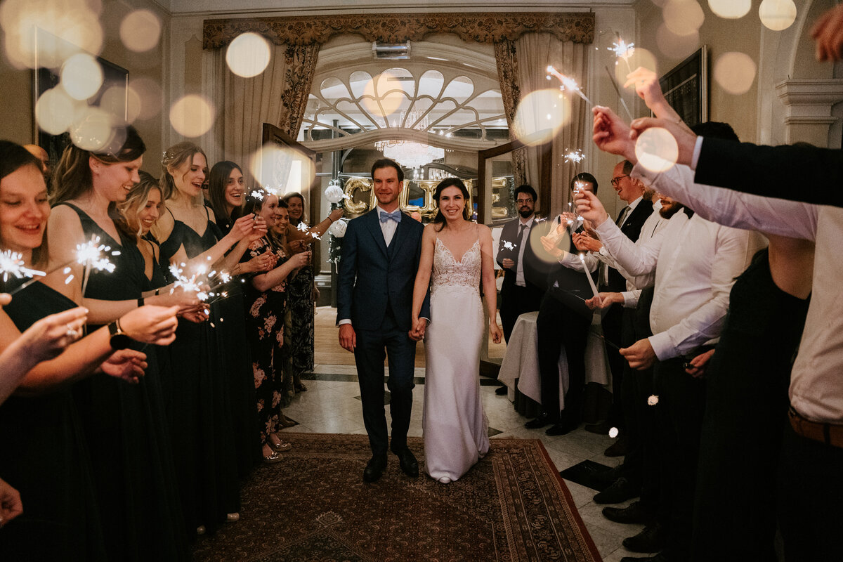 Wedding couple sparkler exit in Parisian chateau