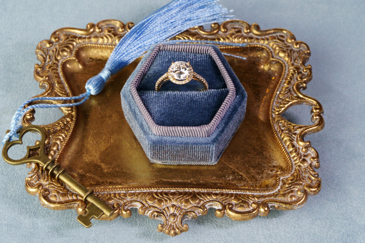 14k gold halo ring in blue velvet box
