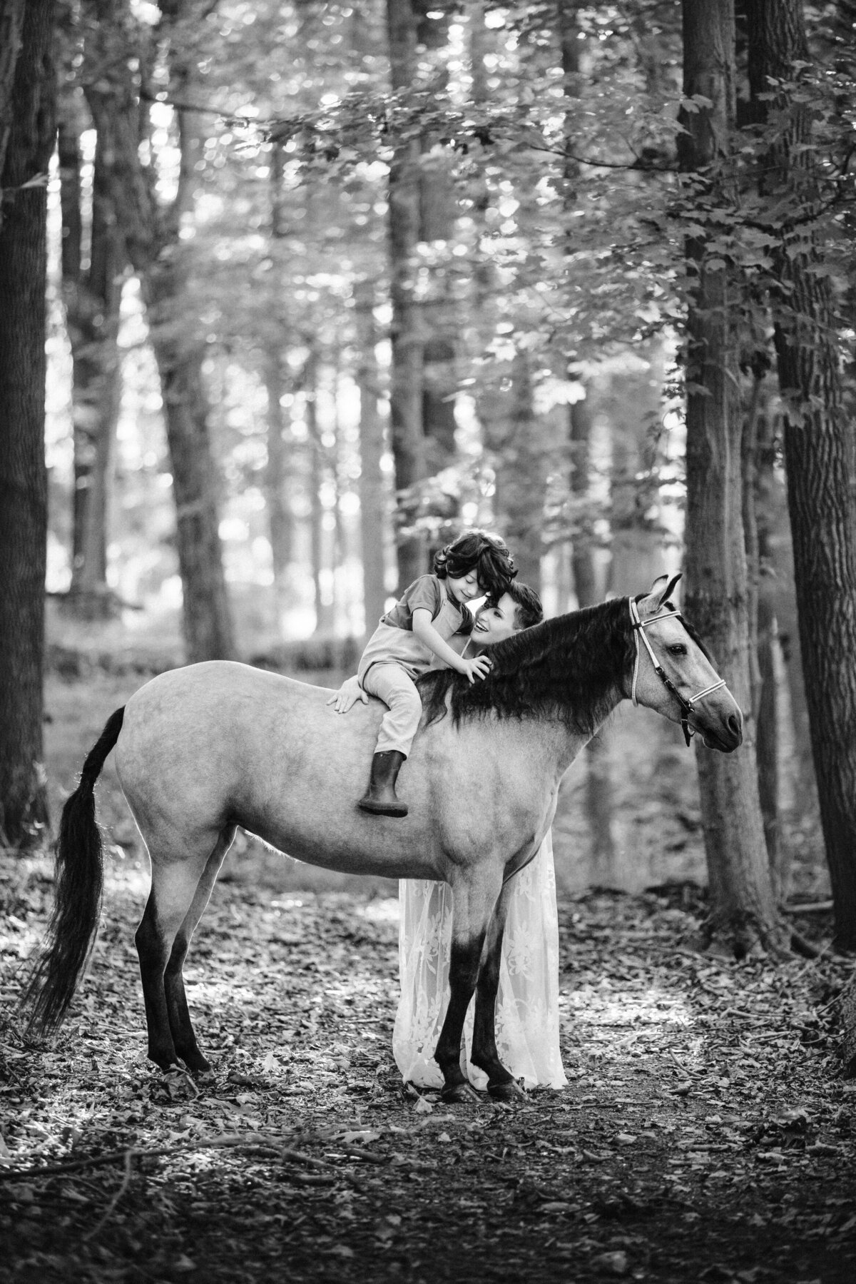 Mother and child take photos on horse during unique family photography session in Princeton, New Jersey.