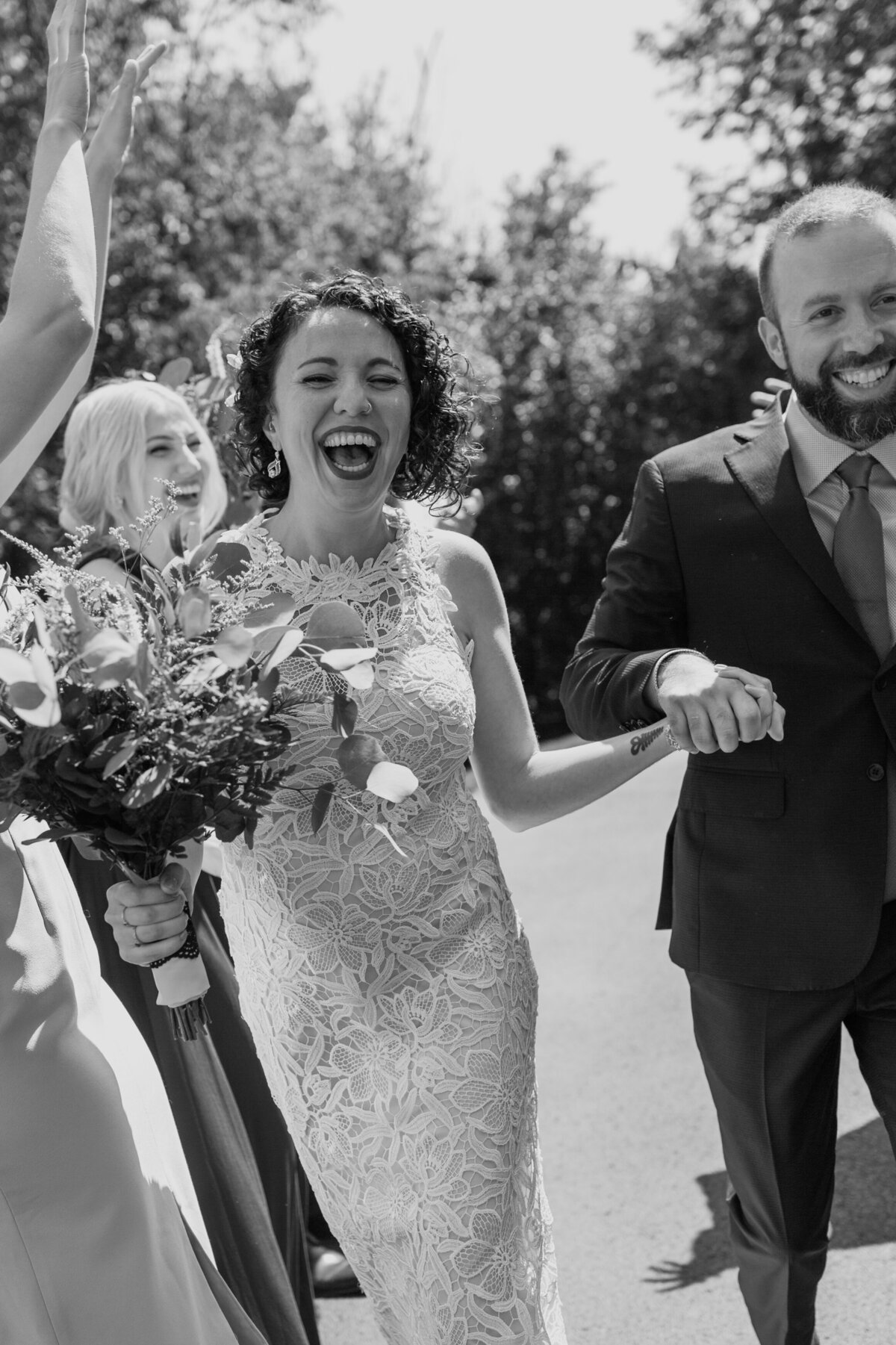 A happy candid moment of a bride and groom and their wedding party captured by Fort Worth wedding photographer, Megan Christine Studio