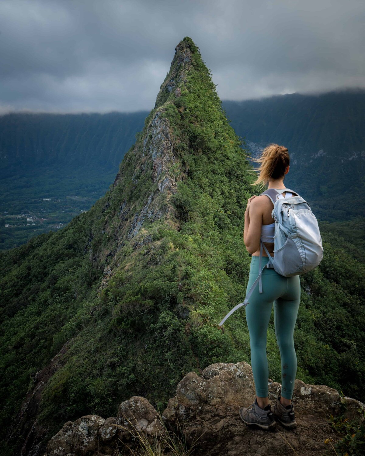 Jess of Jess Wandering wearing Glyder leggings standing on a rock looking at a mountain