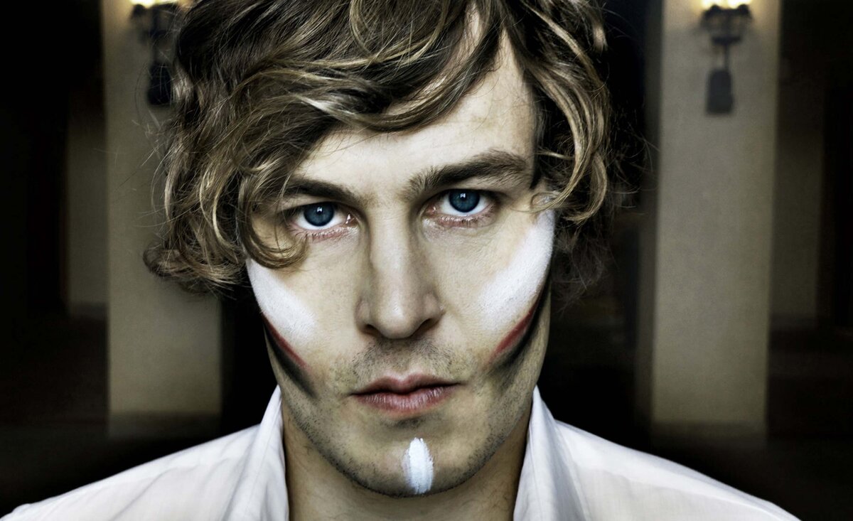 Male musician portrait Ben Rothbard close up white and red make up strips on cheeks