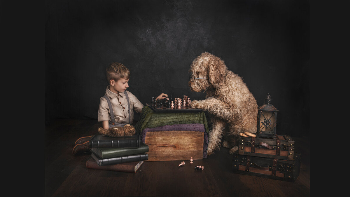 Boy and his dog playing a game of Chess, posed in the Photography Studio/ Sonia Gourlie Fine Art Photography/ Ottawa Ontario