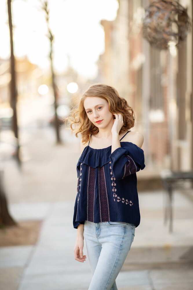 Senior session of young woman posing outside