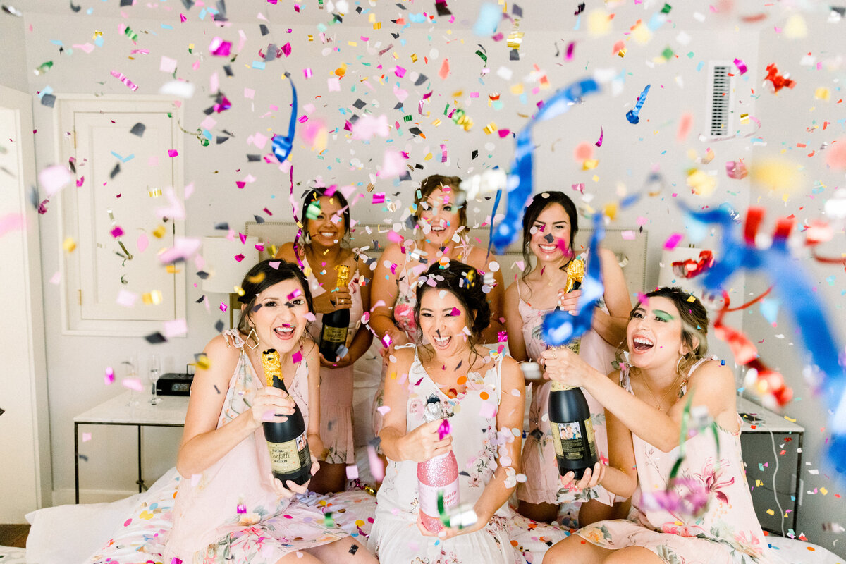 bride and bridesmaids popping confetti canons