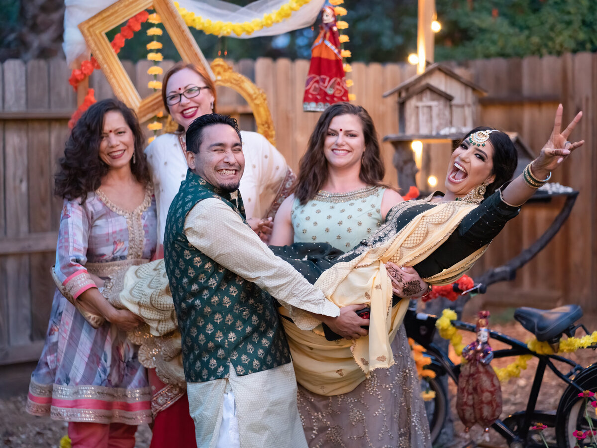 Indian wedding in Sacramento groom lifting the bride