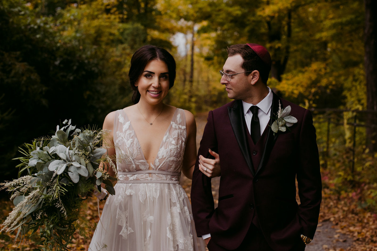 bride and groom on wooded path at outdoor jewish wedding