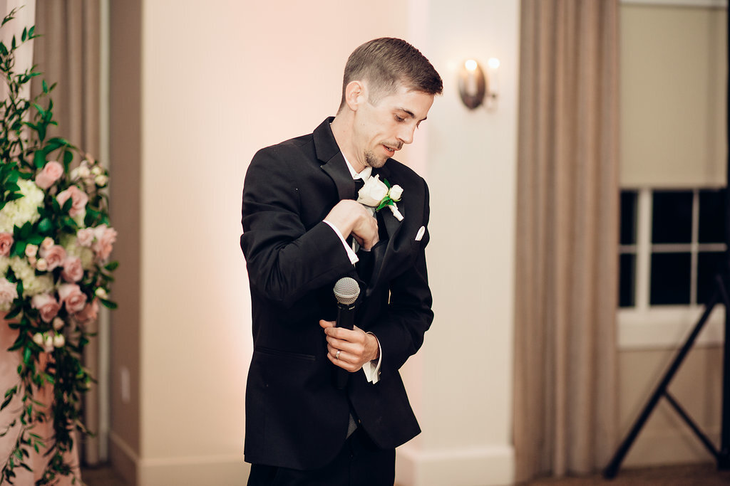 Wedding Photograph Of Groom In Black Suit Standing While Holding a  Microphone Los Angeles