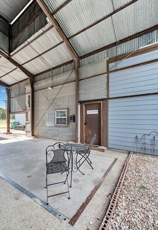 Large garage area with roll up doors at this four-bedroom, four-bathroom vacation rental home and guest house with free WiFi, fully equipped kitchen, firepit and room for 10 in Waco, TX.