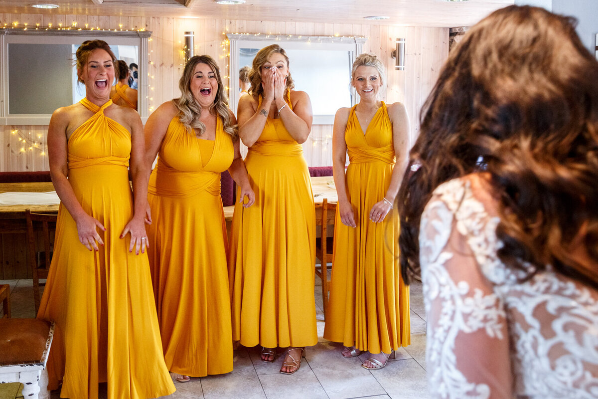 excited bridesmaids seeing bride for the first time