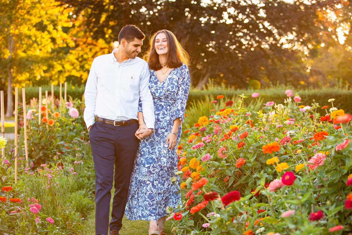 Colombian couple walks through the floral garden at Harkness State Park during their engagement session/