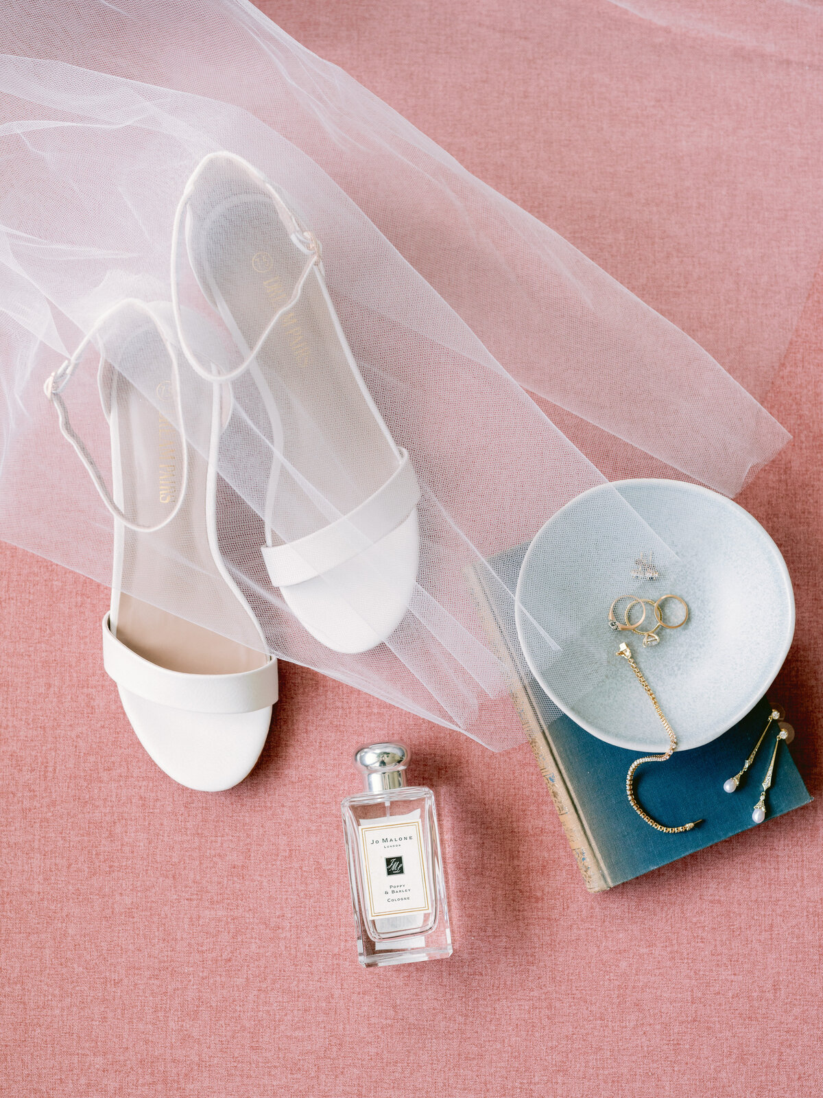 Flatlay of bridal shows, perfume and earrings for wedding at Grand Lady Austin