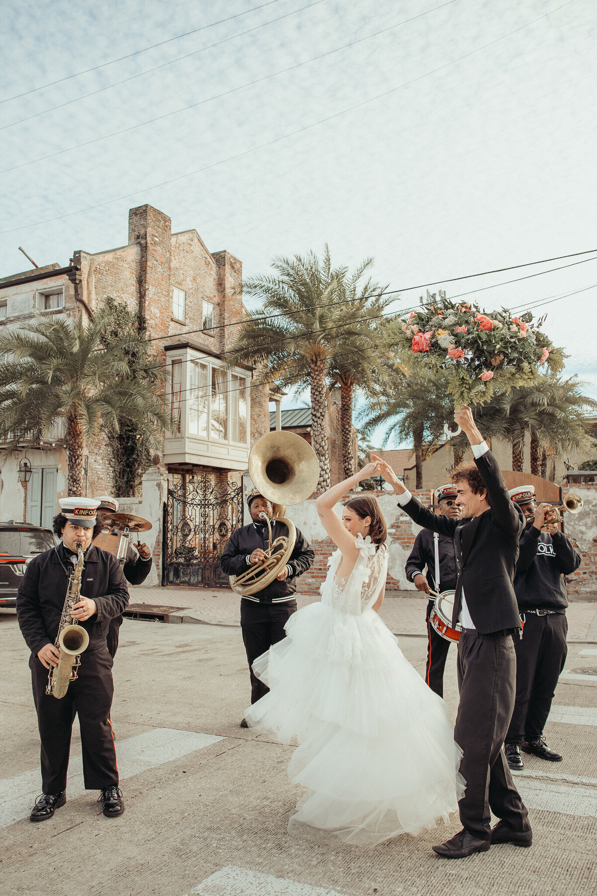 Columbus, Ohio Wedding Photographer in New Orleans at wedding venue Race and Religious photographing couple dancing with band in the street